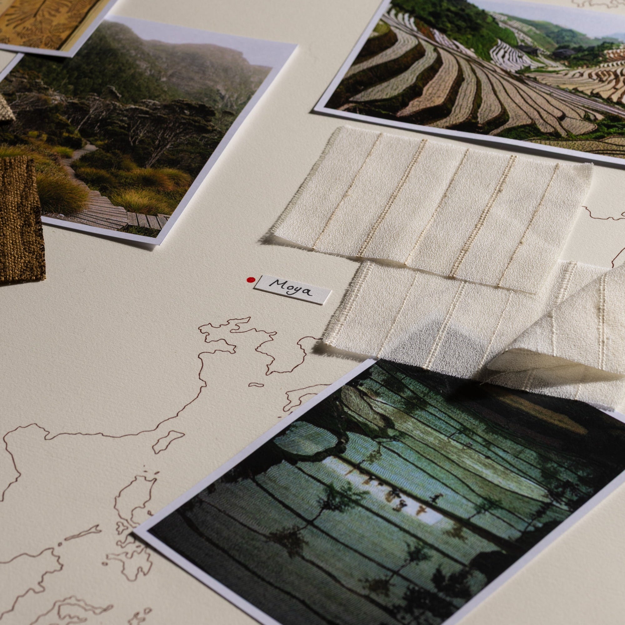 Collection of landscape photos and a map on a flat surface